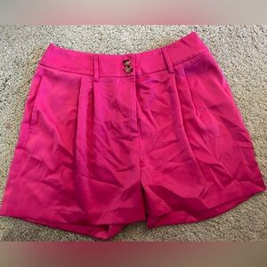 Fuchsia pleated satin shorts with tortoise buttons